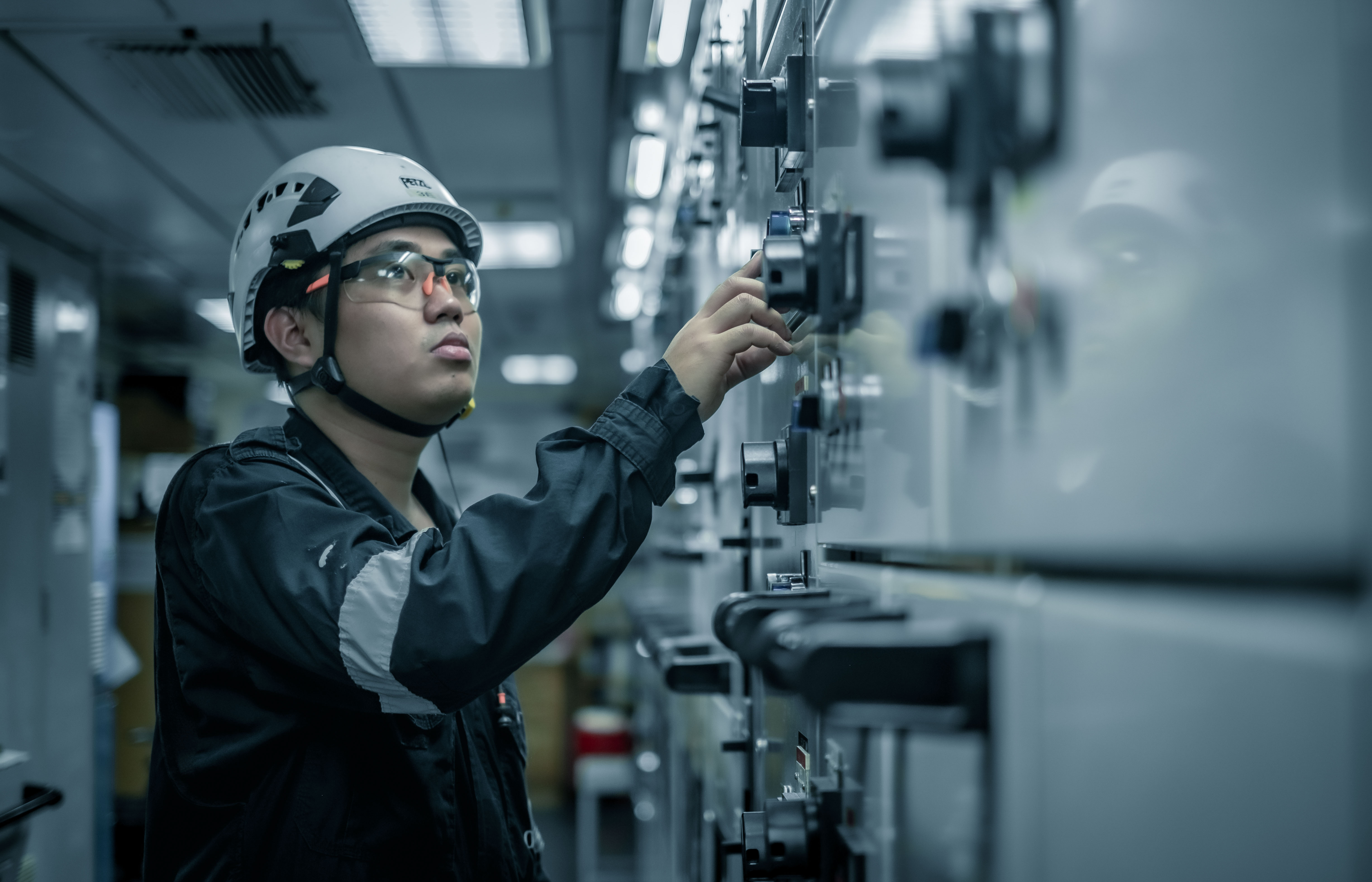 Odfjell marine engineer inspecting control systems in the ship’s engine room.
