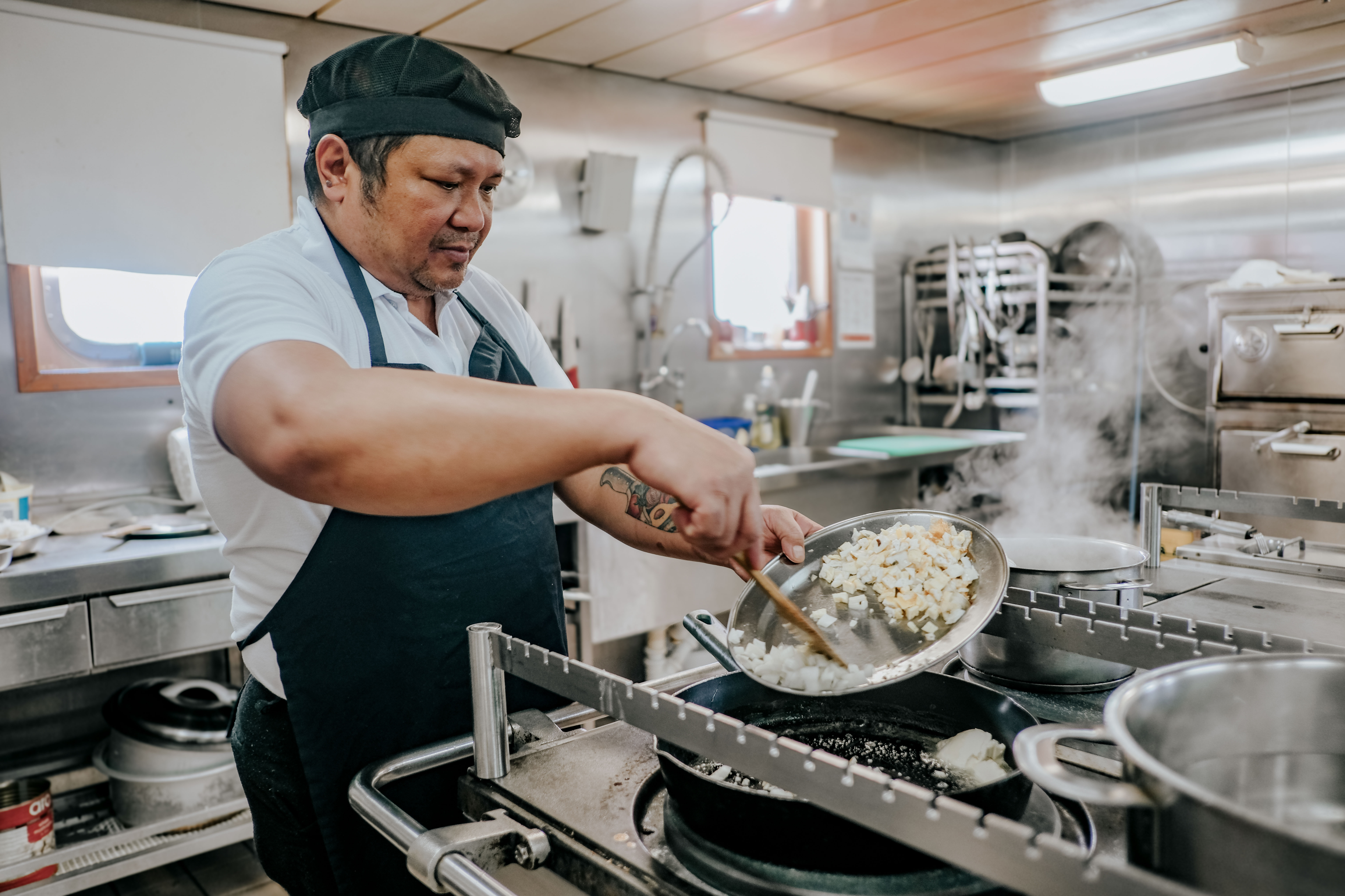 Odfjell ship cook preparing a meal in the galley aboard a chemical tanker.