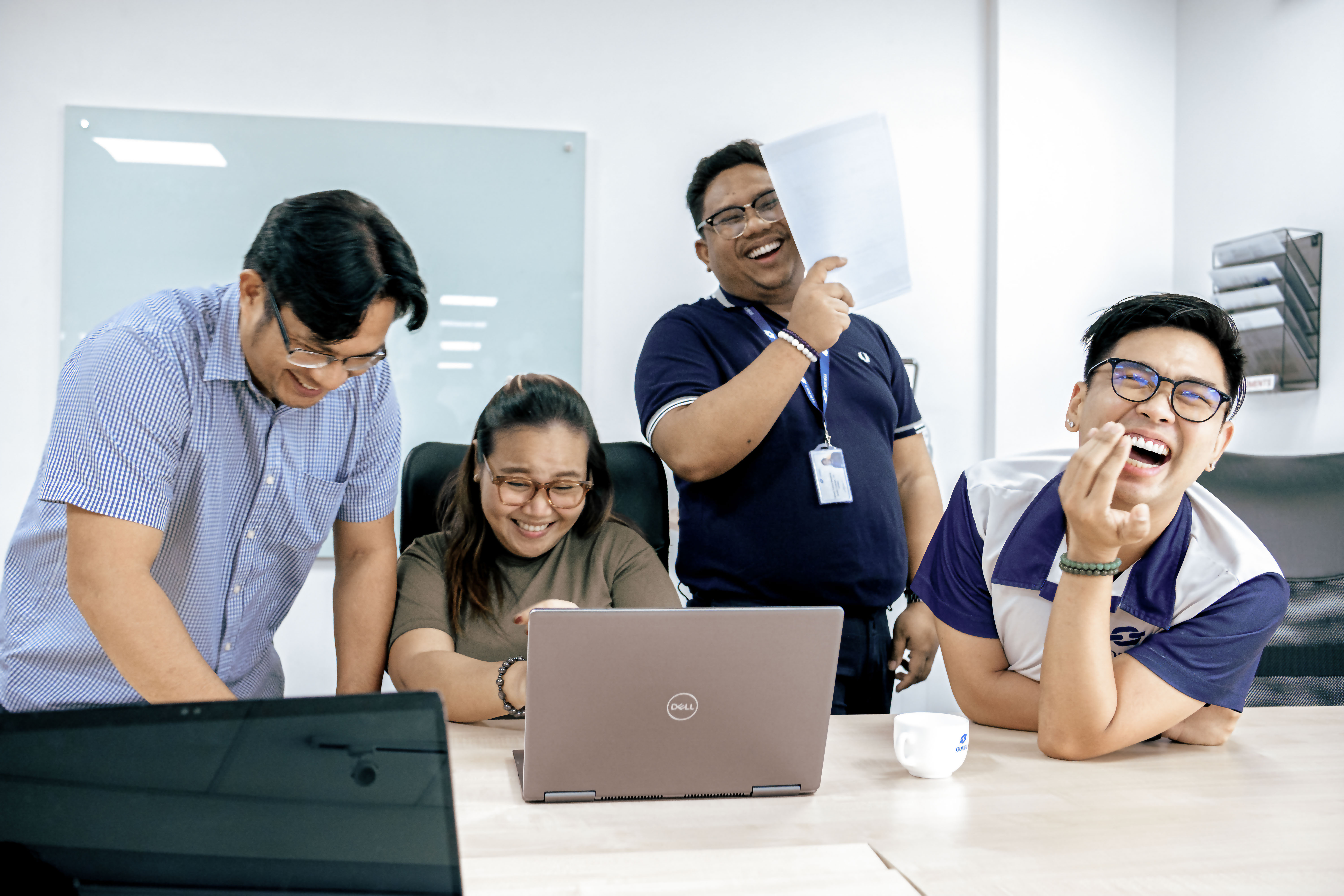 Odfjell Manila office team collaborating and laughing together during a meeting.