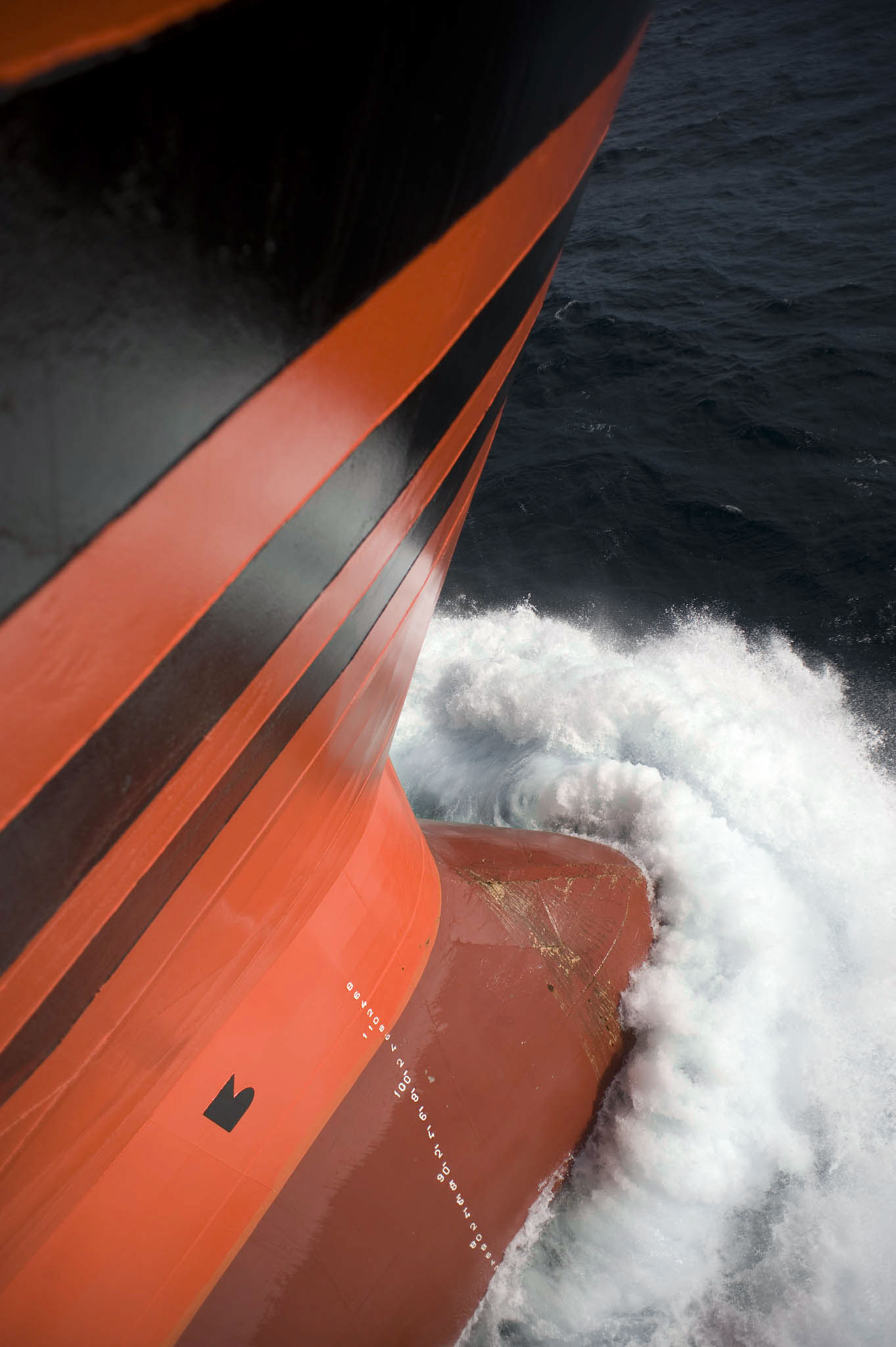 Close-up of Odfjell tanker bow cutting through ocean waves.