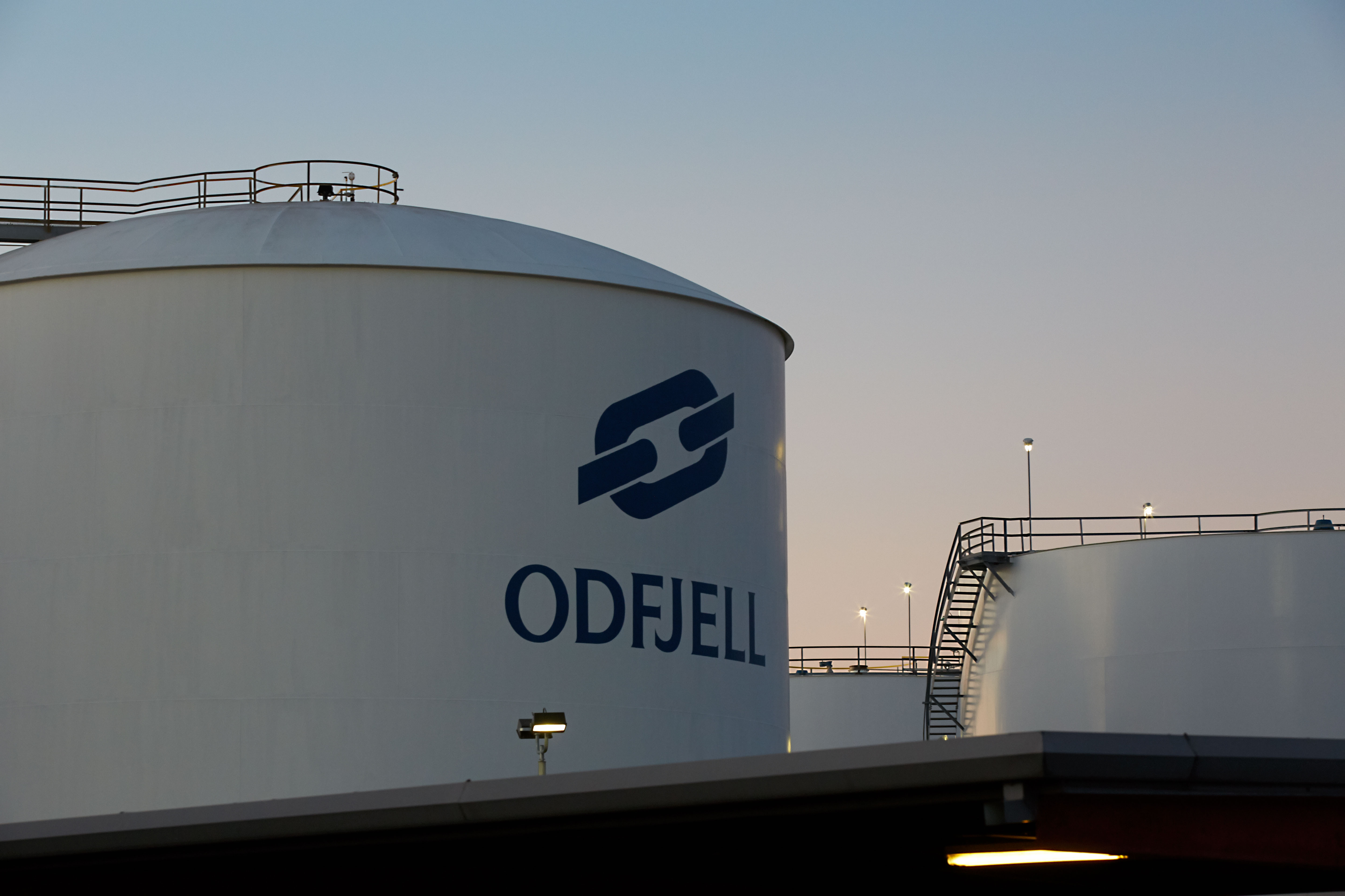Aerial photo of Odfjell terminal’s chemical storage area by the waterfront in golden hour light.