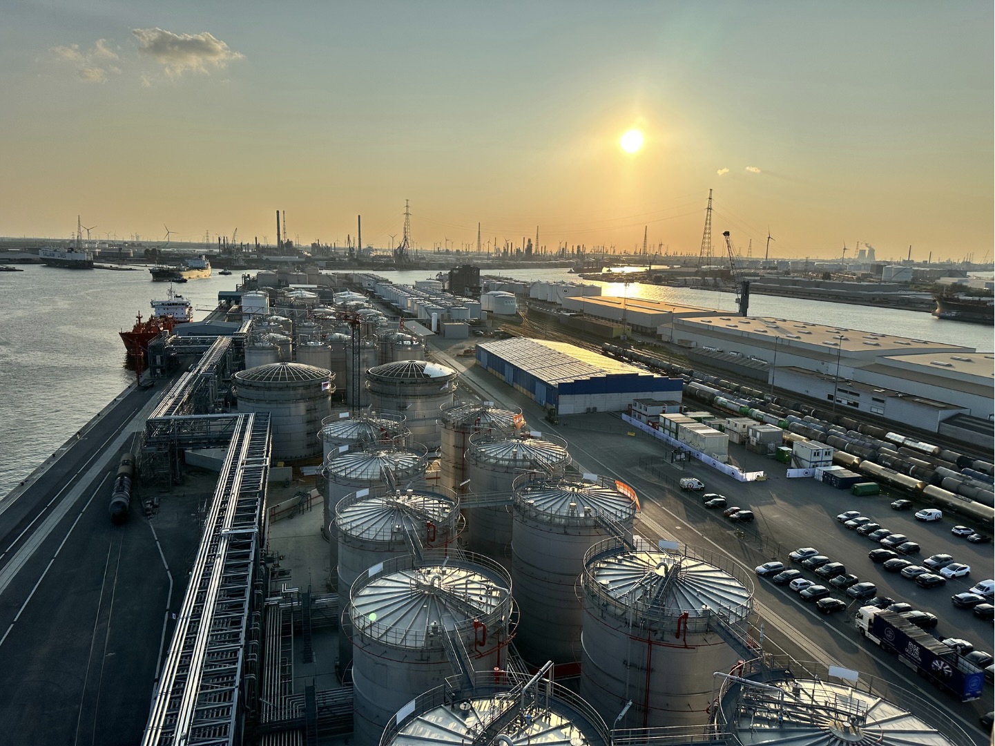 Aerial view of Odfjell terminal and port facility at sunset, with chemical storage tanks and docked vessels.