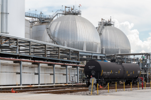 Rail tank car at Odfjell terminal with spherical chemical storage tanks in background.