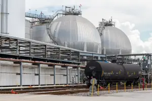 Rail tank car at Odfjell terminal with spherical chemical storage tanks in background.