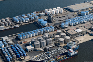Close-up aerial of Odfjell Noord Natie tank terminal showing blue and silver chemical storage tanks and logistics area.