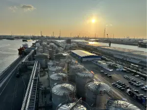 Aerial view of Odfjell terminal and port facility at sunset, with chemical storage tanks and docked vessels.